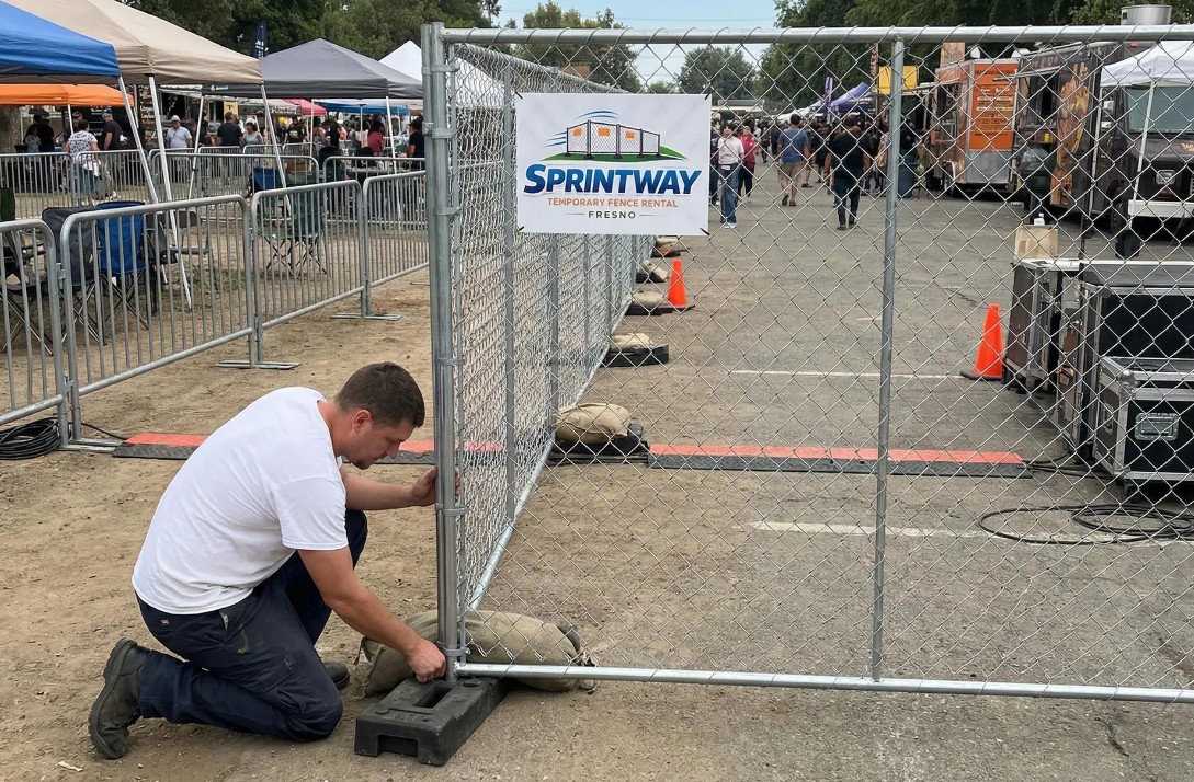 Sprintway Temporary Fence Rental Fresno crew installing chain link temporary fencing at an outdoor event